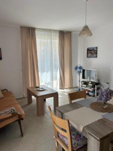 a living room with a table and a television at Villa Alba in Ezerets