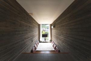 a hallway of a house with wooden walls at Tivoliville Spa N Poolvilla in Pocheon +14 photos