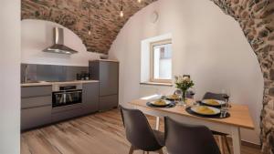 a kitchen with a table with plates of food on it at Chalet Ferrari in Ponte di Legno