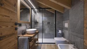 a bathroom with a sink and a toilet and a shower at Chalet Ferrari in Ponte di Legno +25 photos