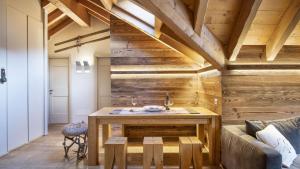 a bathroom with a wooden wall with a sink at Alpen Chalet in Ponte di Legno