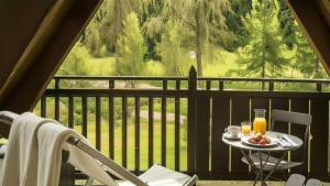 a table with a plate of food on a balcony at Alpen Chalet in Ponte di Legno +35 photos