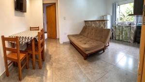a living room with a couch and a table at Casa Ubatuba in Ubatuba +1 photo