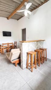 a room with a bar with wooden tables and chairs at Casa Ubatuba in Ubatuba