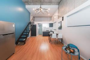 a living room with a staircase and a table and chairs at Daecheon Boryeong the Playa Pension in Boryeong
