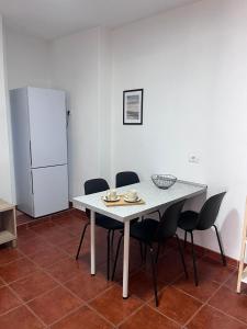 a kitchen with a table and chairs and a refrigerator at El Isleño in Valverde
