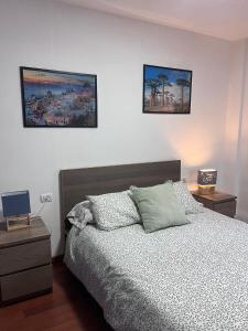 a bedroom with a bed and two pictures on the wall at El Isleño in Valverde