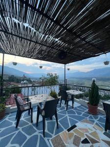 a patio with a table and chairs and a view at Himalayas in Gjirokastër