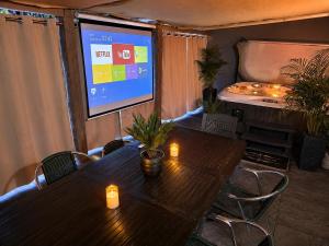 a conference room with a table with candles and a screen at Royal SPA Saarbrucken in Stiring-Wendel