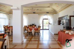 a dining room with tables and chairs at Hotiday Gallipoli Masseria in Gallipoli