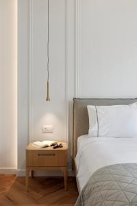 a bedroom with a bed and a nightstand next to a bed at Heronia Suites in Karistos