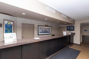 a lobby with a large counter in a waiting room at Days Inn & Suites by Wyndham Brandon in Brandon +63 photos
