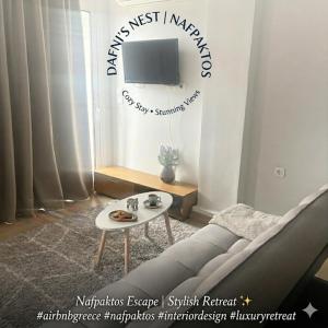 a living room with a couch and a table at Dafni's Nest, Nafpaktos in Nafpaktos