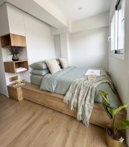 a bedroom with a bed with a wooden floor at Dafni's Nest, Nafpaktos in Nafpaktos