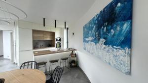 a kitchen with a large painting on the wall at vila Kořenec in Kořenec