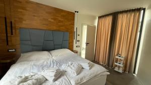 a bedroom with a large white bed with towels on it at vila Kořenec in Kořenec
