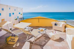 a balcony with a table and chairs and the ocean at Hotel Albatros Varigotti in Varigotti