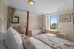 a bedroom with a large bed and a bath tub at Les Pigerolles de Cabris in Cabris +20 photos