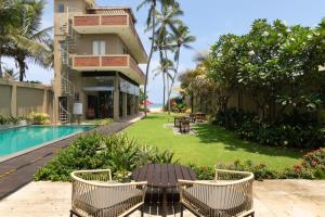 a view of a resort with chairs and a pool at Ayuda Sanctuary Boutique Negombo in Negombo