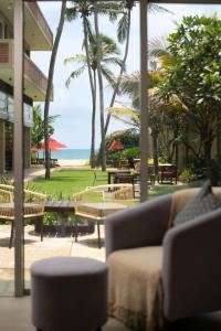 a living room with a couch and a view of the beach at Ayuda Sanctuary Boutique Negombo in Negombo