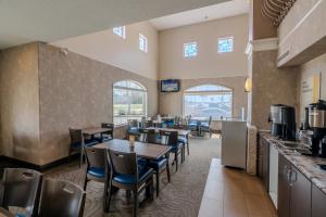 a dining room with tables and chairs in a restaurant at Days Inn & Suites by Wyndham Brandon in Brandon