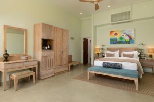 a bedroom with a bed and a desk and a mirror at Ayuda Sanctuary Boutique Negombo in Negombo +34 photos