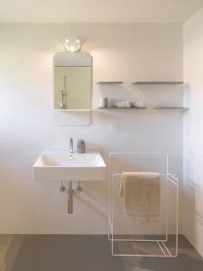 a bathroom with a sink and a mirror at Haus des Onkels in Hittisau
