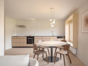 a kitchen and dining room with a table and chairs at Haus des Onkels in Hittisau