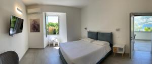 a bedroom with a large white bed and two windows at Villa Franca in Pilzone +81 photos