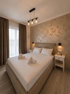 a bedroom with a large bed with two pillows on it at Apartman Ivan with pool in Zagvozd +15 photos