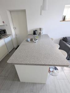 a kitchen with a counter top with a sink at New Barnet Fresh Apartment in New Barnet