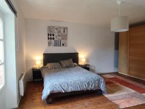 a bedroom with a bed with two night stands and two lamps at Pallancheloc in Amions +7 photos