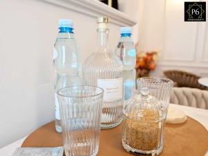 a group of bottles and glasses on a table at P6 Apartament Kaszmirowy in Pisz