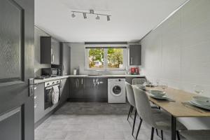 a kitchen with a table and a dining room at The Glasgow Nook in Glasgow