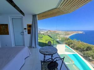 a bedroom with a bed and a view of the ocean at Villa Luxury Paradise in Salobreña