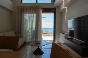 a living room with a view of the ocean at Evi Seaside Suites in Kanali