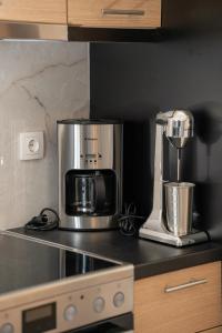 a kitchen with a microwave and a coffee maker on a counter at Evi Seaside Suites in Kanali +12 photos