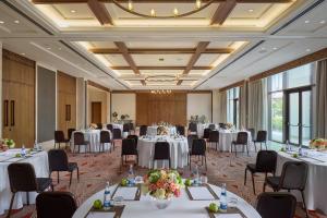 a ballroom with tables and chairs and a room with tables and chairsktop at Mandarin Oriental, Muscat in Muscat +105 photos