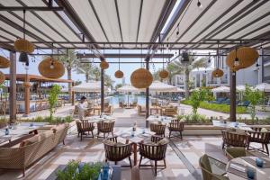 a rendering of a restaurant with tables and chairs at Mandarin Oriental, Muscat in Muscat