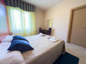 a hotel room with a bed with towels on it at VMHostel in Montecatini Terme