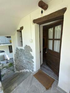 a room with a door and a stone wall at La ca veja in Locana