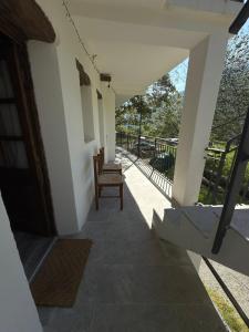 a hallway of a house with a porch with a chair at La ca veja in Locana