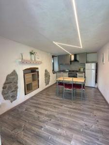 a kitchen with a table and chairs in a room at La ca veja in Locana
