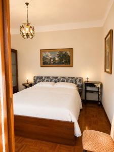 a bedroom with a bed and a chandelier at Charm Studio - Large private terrace, Masserano in Masserano