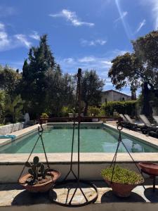 a swing in front of a swimming pool at Casa Melissa in Santo António do Baldio +30 photos