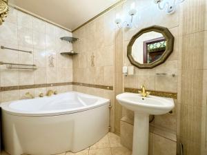 a bathroom with a tub and a toilet and a sink at Jacuzzi With light Nauki Avene in Kharkiv +34 photos