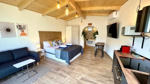 a room with a bed and a couch and a tv at 16 Casita con Jacuzzi privado in Gran Alacant
