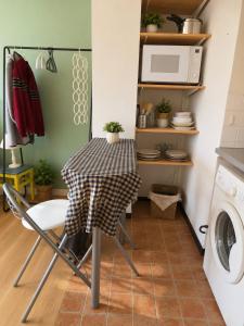 a kitchen with a table and a washing machine at Spacious Studio Paris La villette-Metro in Paris