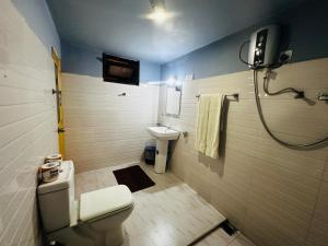 a bathroom with a toilet and a sink at Sigiriya Rock Gate Resort in Sigiriya +115 photos