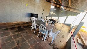 a room with a table and chairs on a patio at Casa California - espaçosa in Formosa +5 photos